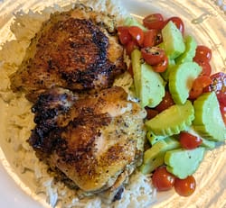 Picture of Lemon Chicken Thighs with creamy coconut rice and a cucumber tomato salad.